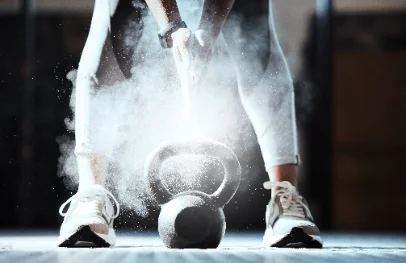 Chalk dust rising over a kettlebell on the gym floor