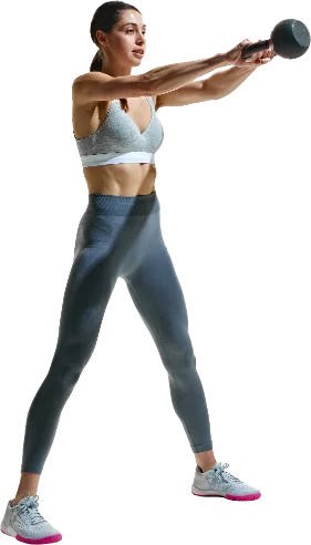 A woman holding a kettlebell at the top of a swing